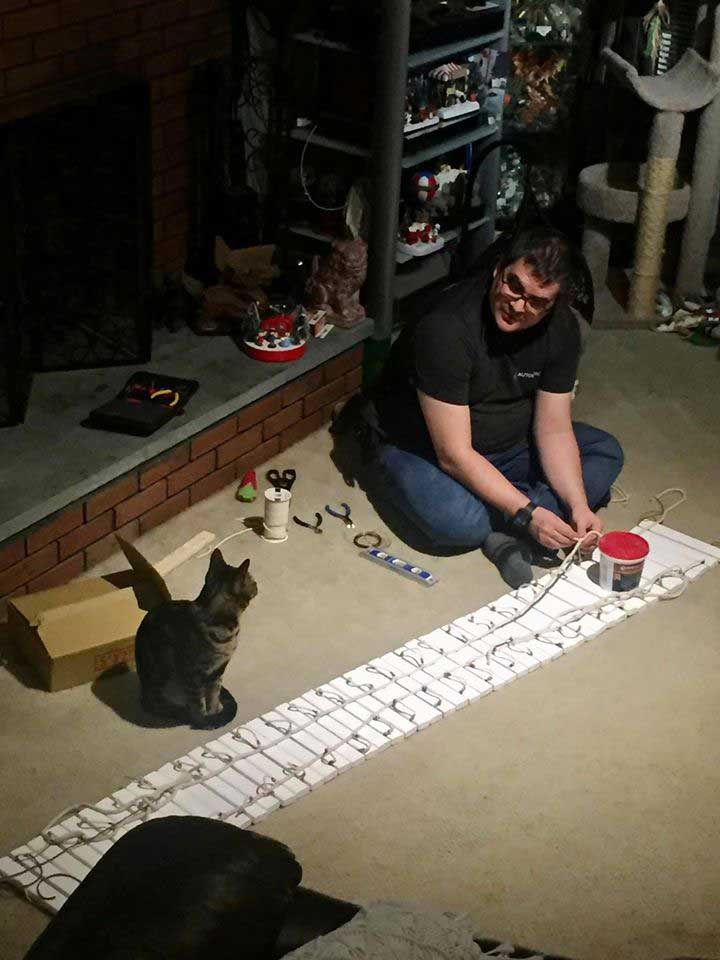 Man building custom towers for cats