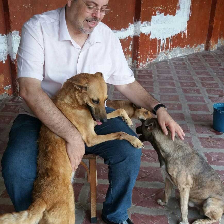 Father Joao with rescued dogs