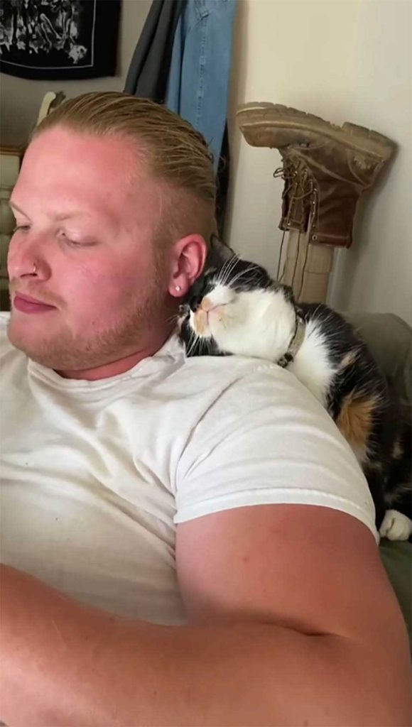 cat waits for dad to help her stretch